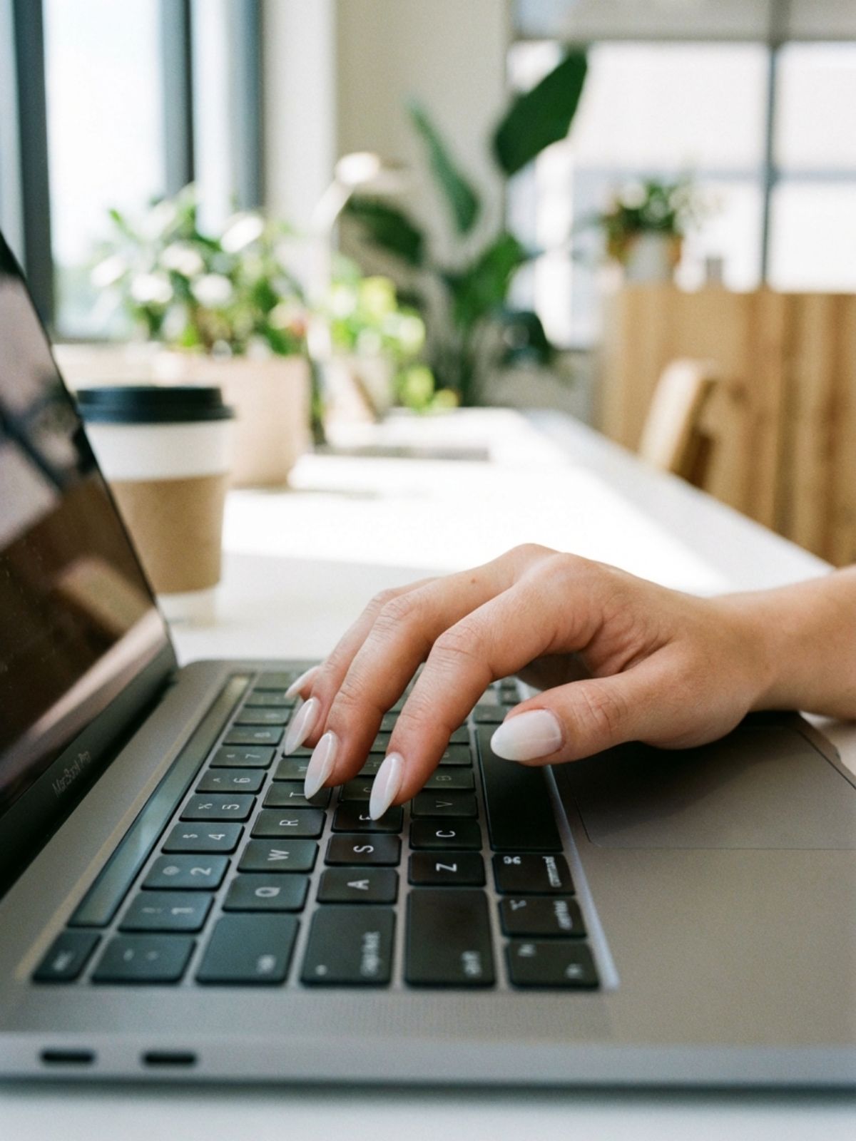 milky white almond nails typing Minimal Nails for Business Trips - Milky white almond nails offer a sophisticated, clean aesthetic that stands out without being loud.